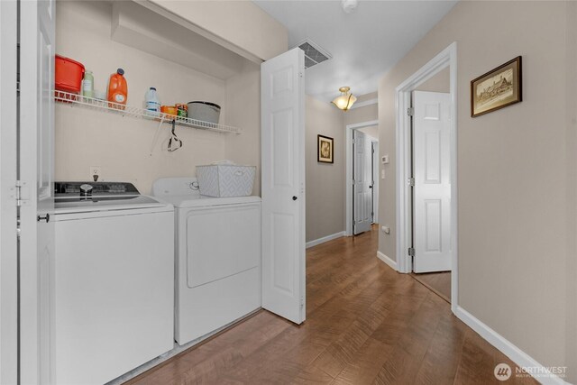 washroom featuring separate washer and dryer and baseboards