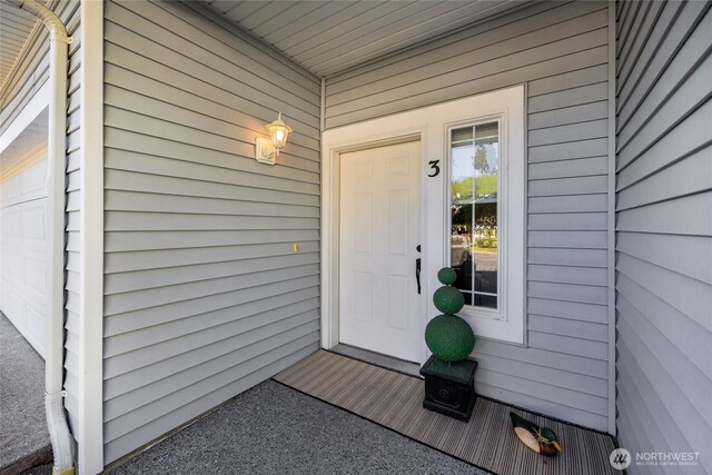 view of exterior entry featuring a garage