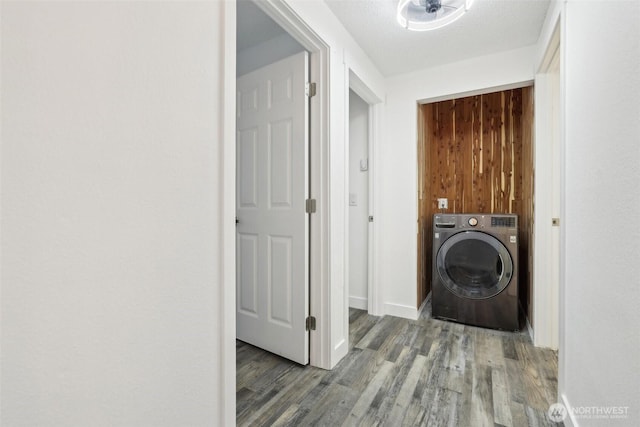 laundry area featuring washer / dryer, wood finished floors, and baseboards