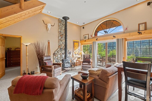 111 Connon Canyon Rd, Leavenworth, WA 98826 - living room featuring a wood stove, high vaulted ceiling, carpet floors, and ornamental molding