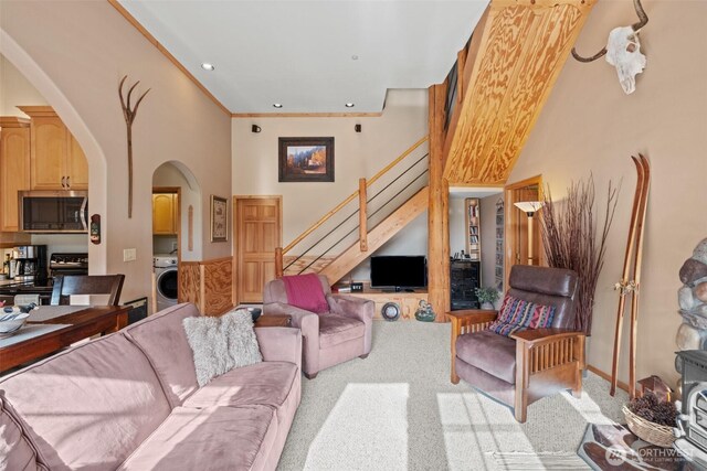 111 Connon Canyon Rd, Leavenworth, WA 98826 - carpeted living area featuring arched walkways, washer / clothes dryer, stairs, a towering ceiling, and recessed lighting