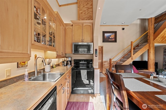 111 Connon Canyon Rd, Leavenworth, WA 98826 - kitchen with black appliances, a sink, light wood-style floors, light brown cabinets, and glass insert cabinets
