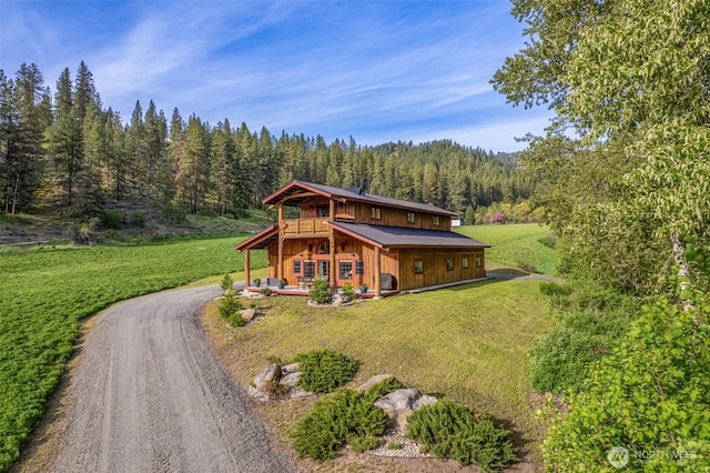 111 Connon Canyon Rd, Leavenworth, WA 98826 - rear view of property featuring a forest view, a yard, driveway, and a deck