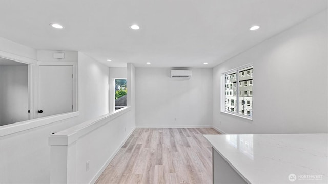 911 Hiawatha Pl S, Seattle, WA 98144 - unfurnished room featuring healthy amount of natural light, recessed lighting, wood finished floors, an AC wall unit, and baseboards