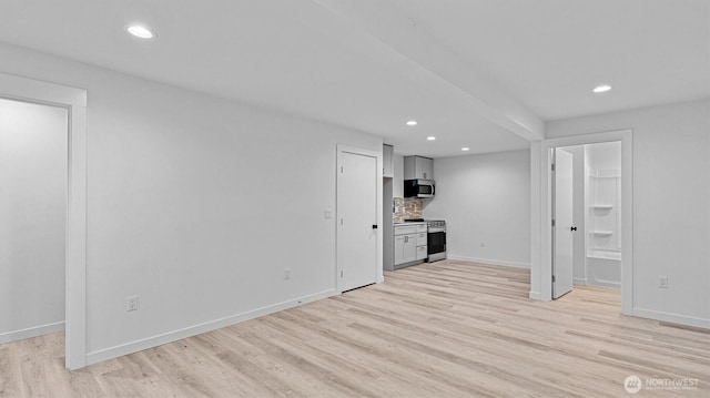 911 Hiawatha Pl S, Seattle, WA 98144 - unfurnished living room with light wood-style floors, recessed lighting, and baseboards