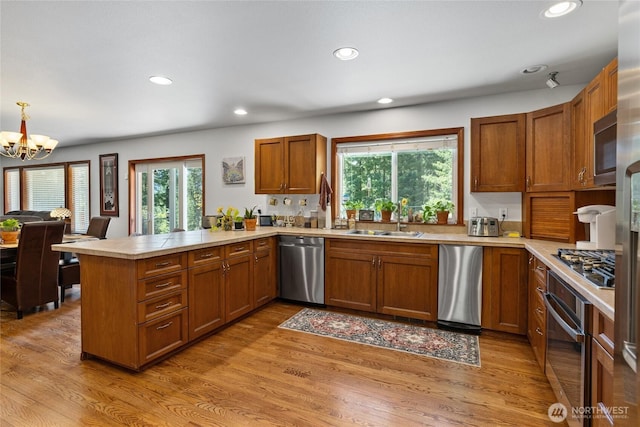 201 Double O Rd, Ronald, WA 98940 - kitchen with appliances with stainless steel finishes, a sink, a peninsula, light countertops, and brown cabinets