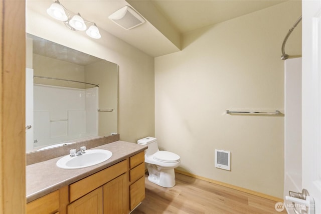 10109 186th St E Unit 249, Puyallup, WA 98371 - bathroom with wood finished floors, toilet, vanity, heating unit, and baseboards