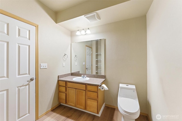 10109 186th St E Unit 249, Puyallup, WA 98371 - bathroom featuring wood finished floors, toilet, vanity, and baseboards