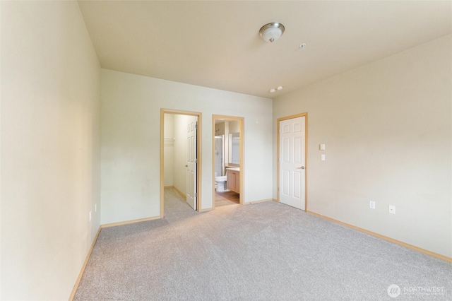 10109 186th St E Unit 249, Puyallup, WA 98371 - unfurnished bedroom with light colored carpet, baseboards, a spacious closet, and ensuite bathroom