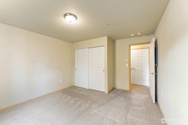 10109 186th St E Unit 249, Puyallup, WA 98371 - unfurnished bedroom with light colored carpet, baseboards, and a closet