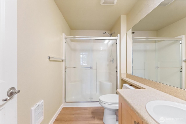 10109 186th St E Unit 249, Puyallup, WA 98371 - bathroom with wood finished floors, a stall shower, vanity, baseboards, and toilet
