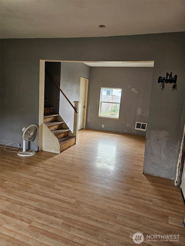 906 SW Mayer, Winlock, WA 98596 - unfurnished living room with wood finished floors and stairs