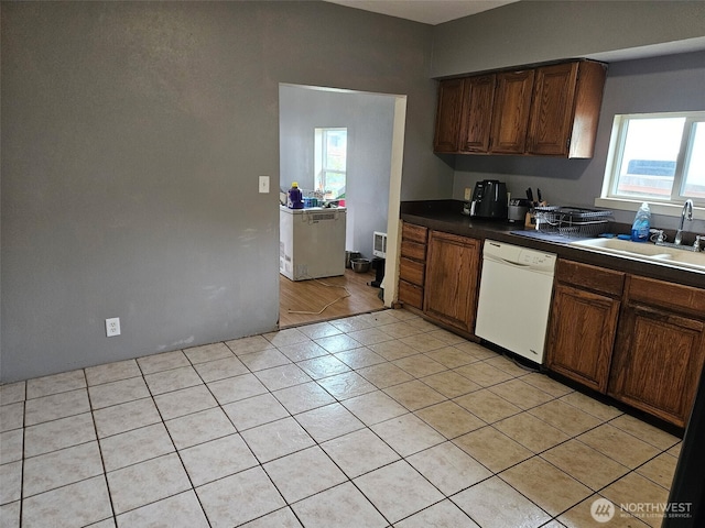 906 SW Mayer, Winlock, WA 98596 - kitchen featuring dishwasher, a sink, dark countertops, and light tile patterned flooring
