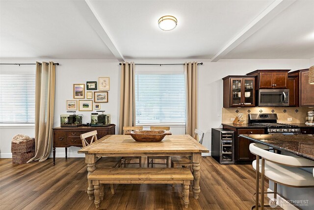 dining area featuring dark wood-style floors and beamed ceiling