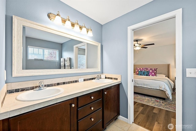 full bathroom featuring ensuite bathroom, ceiling fan, double vanity, and wood finished floors