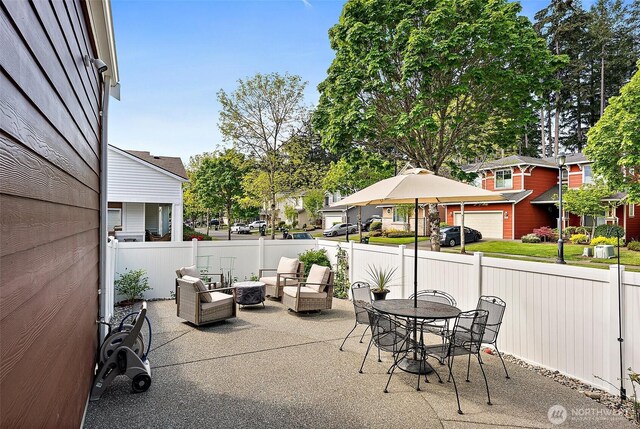 view of patio / terrace featuring fence, outdoor lounge area, and a residential view