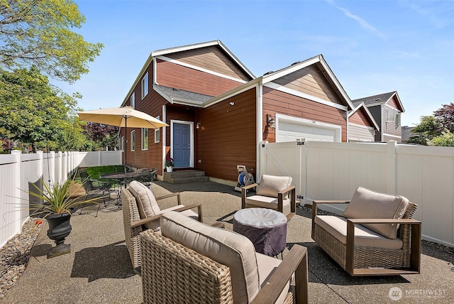 view of patio / terrace featuring a fenced backyard, outdoor lounge area, and a garage