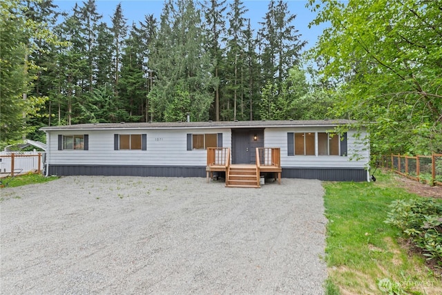 1071 Red Valley Ln, Maple Falls, WA 98266 - manufactured / mobile home with fence, gravel driveway, and a wooden deck