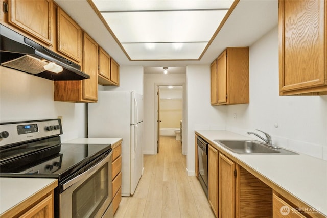 kitchen with electric range, under cabinet range hood, a sink, light wood-style flooring, and black dishwasher