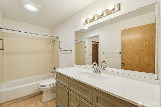 full bath featuring toilet, shower / washtub combination, vanity, and wood finished floors