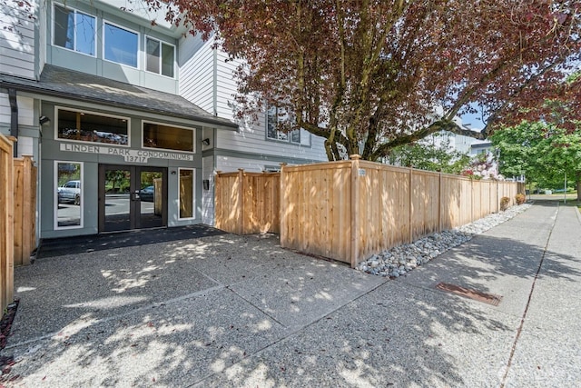 doorway to property featuring french doors and fence