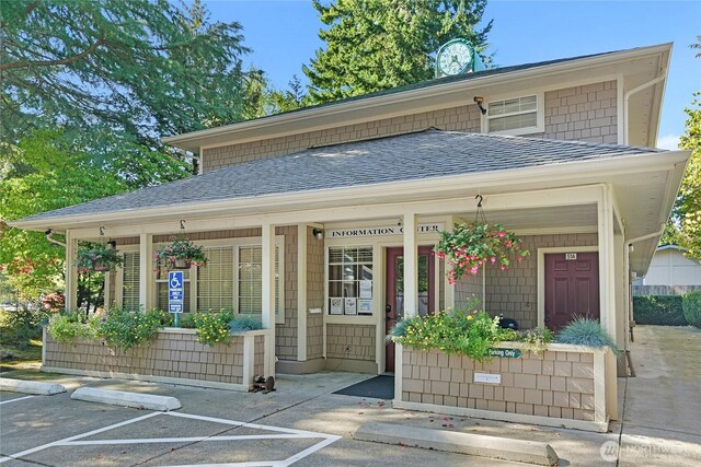 view of outbuilding with a porch and uncovered parking
