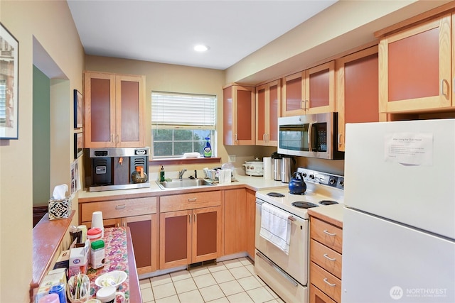 kitchen featuring white appliances, a sink, light countertops, light tile patterned floors, and recessed lighting