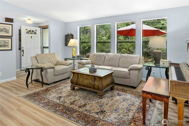 living area with wood finished floors and baseboards