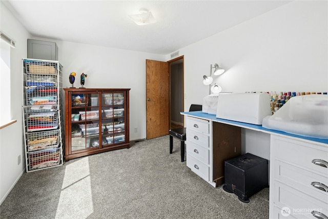 office area featuring light carpet and baseboards