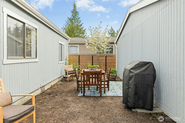 view of patio / terrace featuring a grill and fence