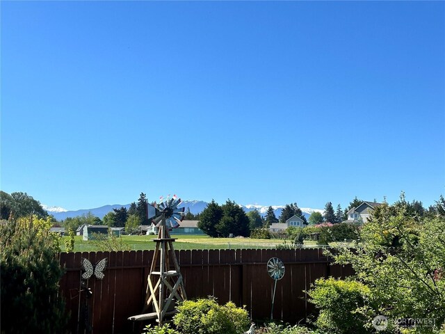 view of yard with fence and a mountain view