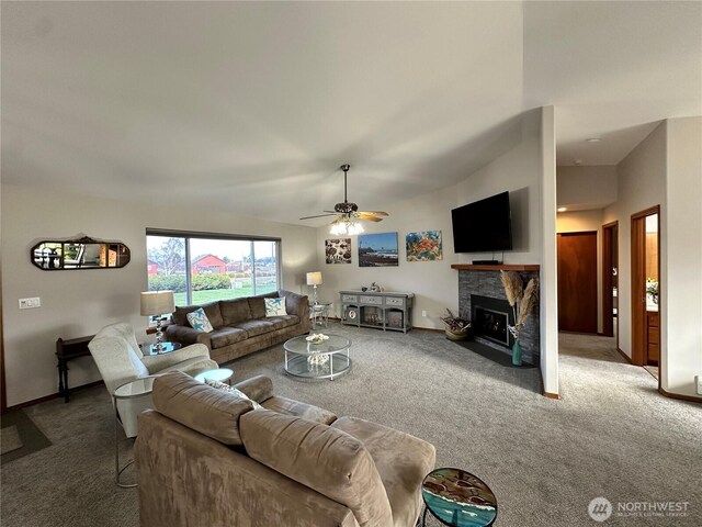 carpeted living area with a ceiling fan, a fireplace with flush hearth, and baseboards