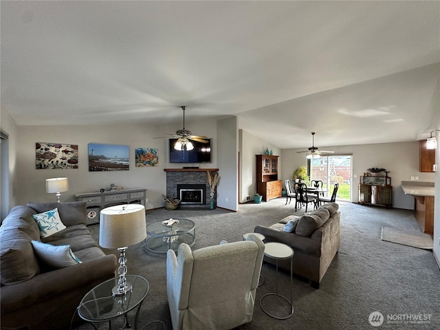 carpeted living area featuring a ceiling fan, a fireplace, and vaulted ceiling