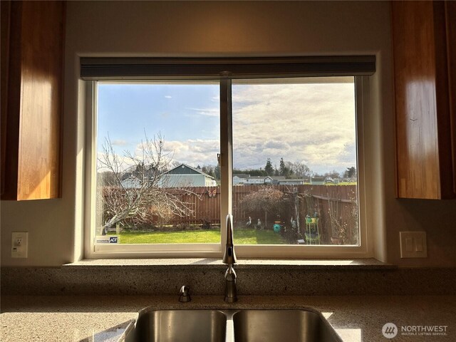 kitchen view of a sink and stone counters