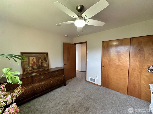 carpeted bedroom with ceiling fan and baseboards
