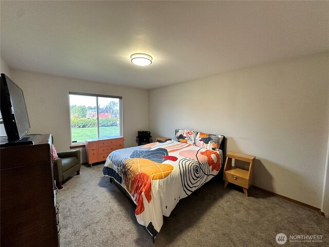bedroom featuring light colored carpet and baseboards