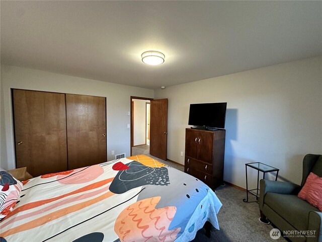 bedroom with carpet, a closet, and baseboards