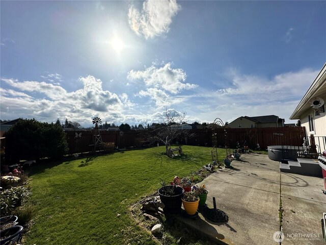 view of yard featuring a patio area and a hot tub