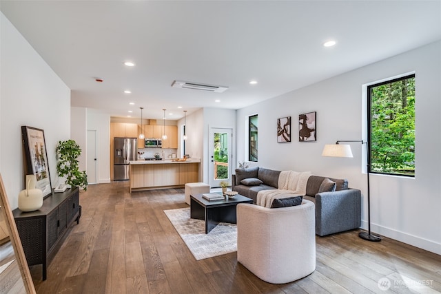 22513 Clearland Ln SE, Yelm, WA 98597 - living area with dark wood-style flooring, recessed lighting, and baseboards