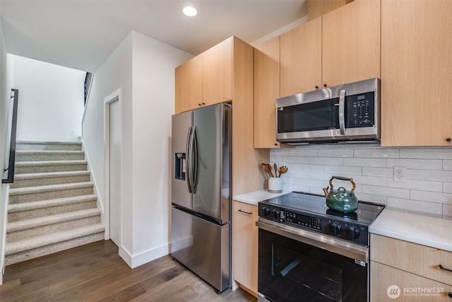 22513 Clearland Ln SE, Yelm, WA 98597 - kitchen with appliances with stainless steel finishes, light brown cabinetry, light countertops, baseboards, and dark wood-type flooring