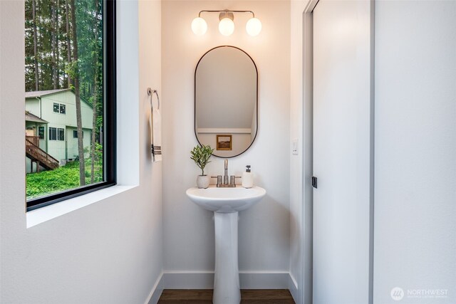 22513 Clearland Ln SE, Yelm, WA 98597 - bathroom featuring plenty of natural light, baseboards, wood finished floors, and a sink