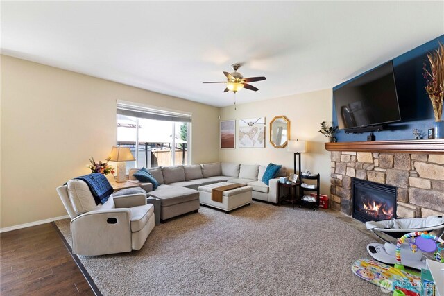 19424 E 26th Avenue Ct E, Spanaway, WA 98387 - living area with a ceiling fan, a fireplace, wood finished floors, and baseboards