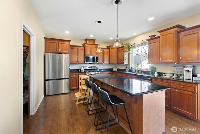 19424 E 26th Avenue Ct E, Spanaway, WA 98387 - kitchen with appliances with stainless steel finishes, brown cabinetry, a center island, and recessed lighting