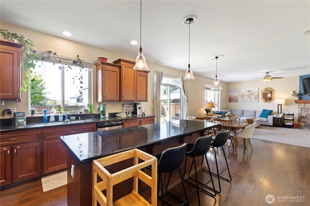 19424 E 26th Avenue Ct E, Spanaway, WA 98387 - kitchen with a sink, open floor plan, dishwasher, a breakfast bar area, and a ceiling fan