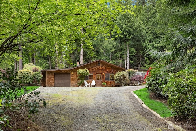 15790 Agatewood Rd NE, Bainbridge Island, WA 98110 - view of front facade with gravel driveway and an attached garage