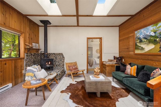 15790 Agatewood Rd NE, Bainbridge Island, WA 98110 - living room with wood walls, a skylight, a wood stove, and baseboard heating
