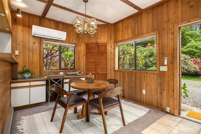 15790 Agatewood Rd NE, Bainbridge Island, WA 98110 - dining space featuring a wall unit AC, plenty of natural light, wood walls, and a chandelier