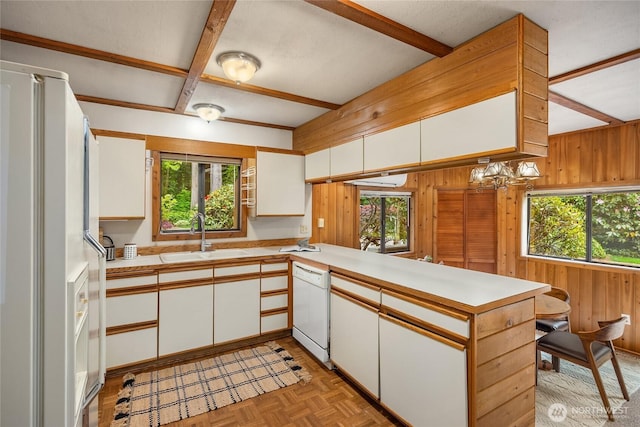 15790 Agatewood Rd NE, Bainbridge Island, WA 98110 - kitchen with white appliances, a sink, healthy amount of natural light, wood walls, and beam ceiling