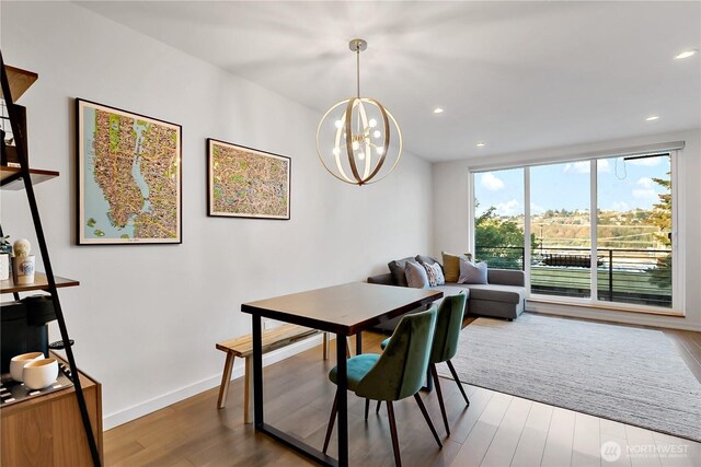2273 14th Ave W, Seattle, WA 98119 - dining space with wood finished floors, a chandelier, recessed lighting, and baseboards