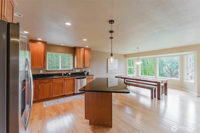 8070 Kispiox Rd, Blaine, WA 98230 - kitchen with stainless steel appliances, light wood-style floors, plenty of natural light, a sink, and a textured ceiling